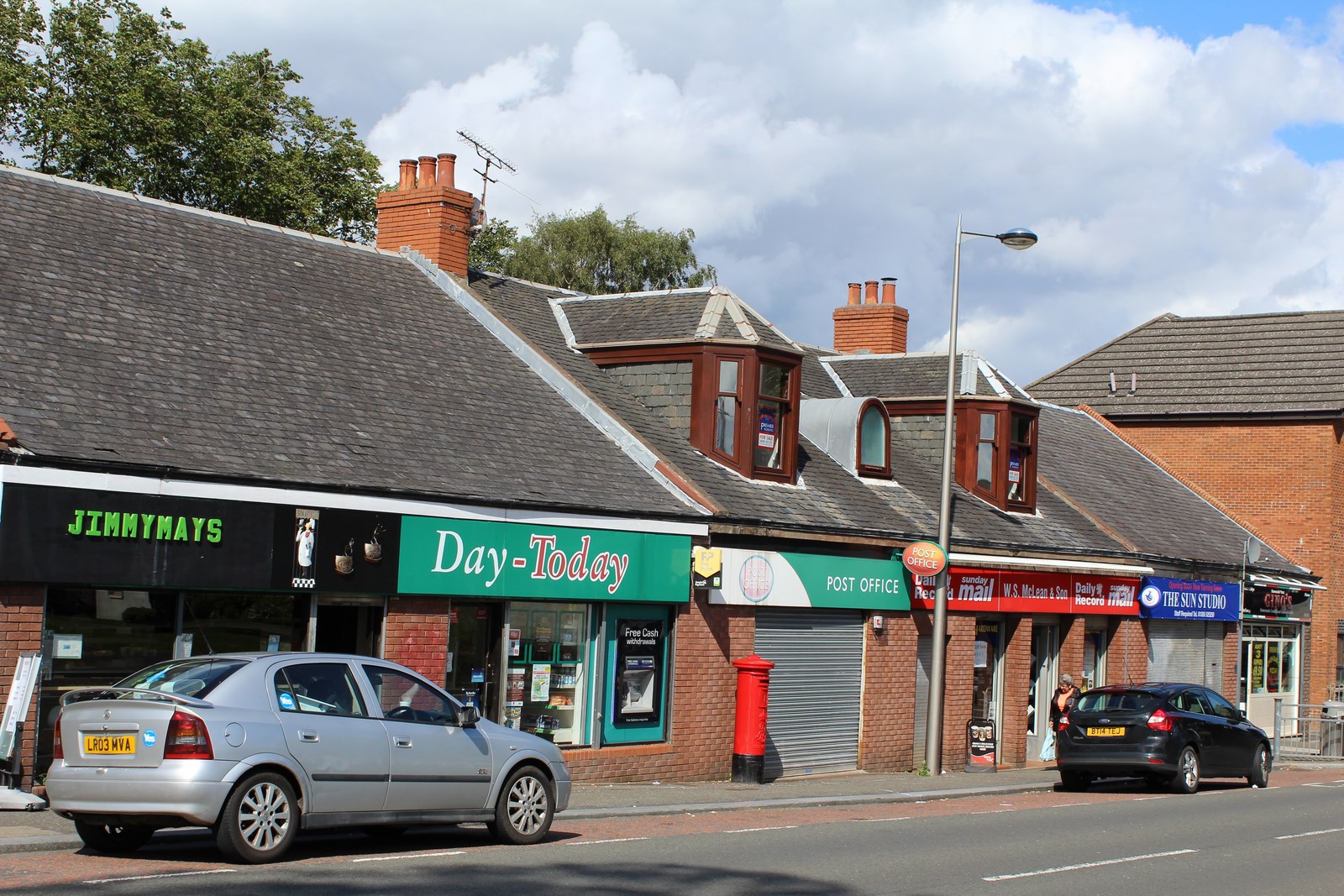 Main Street in High Blantyre, with traditional stone buildings along the road